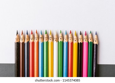 Color pencils with faces painted on them. the concept of a multinational family and equality in the world. - Shutterstock ID 1145374085