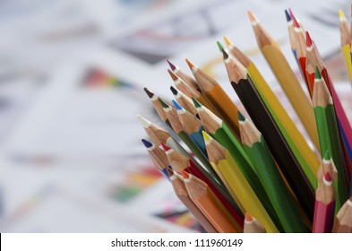 Color pencils isolated on drawing papers background close up