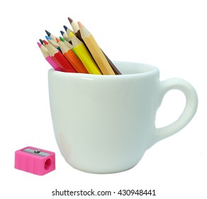 Color pencils in a white cup with pink sharper on the left. - Powered by Shutterstock