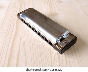 Color photo old harmonica in wood