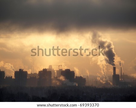 Color photograph of industrial buildings at sunset