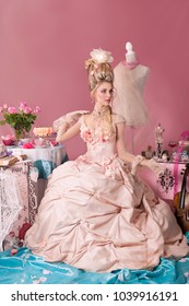 Color portrait of woman dressed as Marie Antoinette in pink