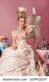 Color portrait of woman dressed as Marie Antoinette in pink