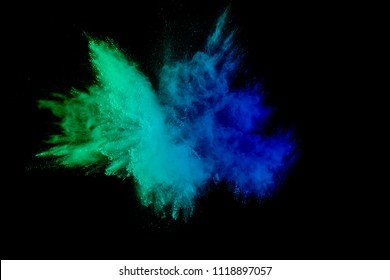color powder explosion cloud isolated on black background. Freeze motion of color dust  particles splashing.