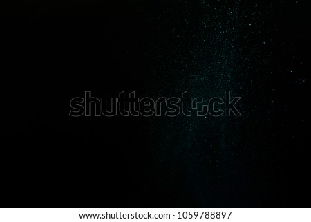 color powder explosion cloud isolated on black background. Freeze motion of color dust particles splash.