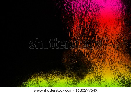 color powder explosion cloud isolated on black background. Freeze motion of color dust particles splashing. 
