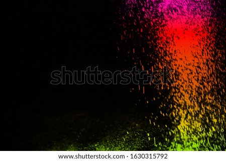 color powder explosion cloud isolated on black background. Freeze motion of color dust particles splashing. 
