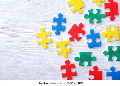 Color puzzles on wooden background
