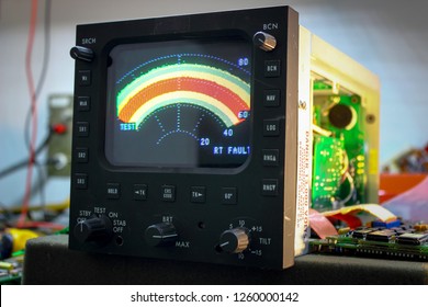 Color  RADAR indicator of weather radar  ,Avionics equipment in aircraft with maintenance. - Shutterstock ID 1260000142
