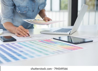 Color samples, colour chart, swatch sample, Graphic designer being selecting Color table and graphics tablet, pen at workplace with work example on wooden desk. - Shutterstock ID 794549566