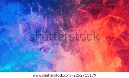 Color smoke abstract background. Cold hot. Ice fire flame. Defocused blue red contrast paint splash light glowing vapor floating cloud texture.