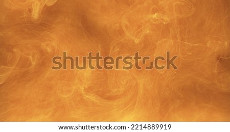 Color smoke cloud. Ink water texture. Steam flow. Orange yellow glowing vapor swirl floating bright abstract art copy space background.