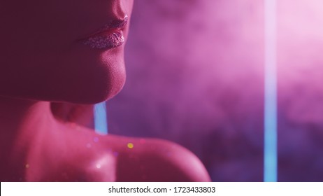Color Smoke Face. Night Glam. Woman With Glitter Lips Bare Shoulder In Purple Neon Light.