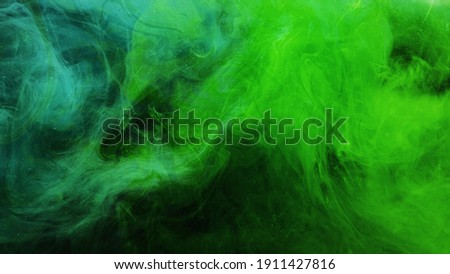 Color smoke. Neon abstract background. Paint in water explosion. Toxic air pollution. Glowing bright green glitter vapor splash mix on dark.