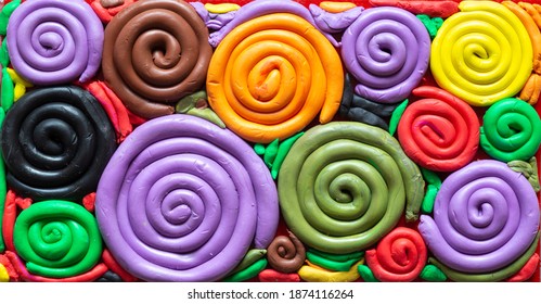 Color Spectrum Made Of Play Dough - Coil-shaped Colorful Artistic Creation - Children's Creativity. Spiral Snail Shells Made Of Doh.