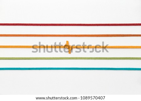 color strings line pattern on white background. orange thread with knot isolated.
