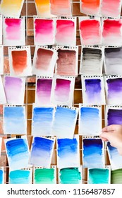 Color Swatch For Painting Background. Watercolor Palette Or Ink Mixes On Paper. Drawing Class Or Courses. Art Painting Skills Practice. Free Space Concept. Woman Hand Choosing.