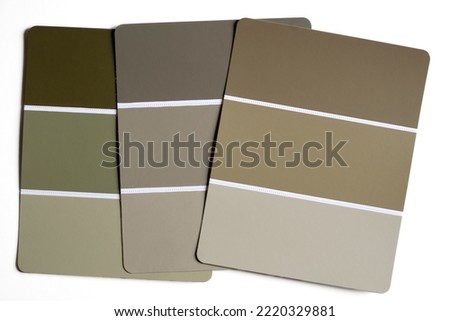Color swatches on a table. Autumnal and winter shades of green, khaki, taupe, brown and beige. Fall color schemes. Interior design color pallet. Creative color inspiration. Monochromatic colors.