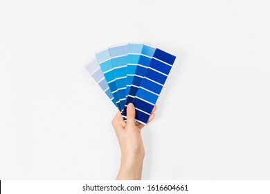 Color swatches with color of the year 2020 in the hand - Classic Blue. Color trend palette. Top view, flat lay. 