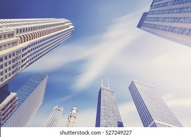 Color toned photo of Chicago skyscrapers with motion blurred clouds, Illinois, USA.