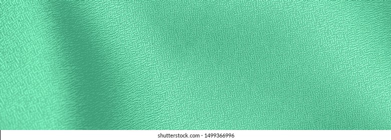 COLOR TREND 2020 Neo mint. Abstract new mint color background. Sea-foam Green satin background. Soft silk fashion background. Green satin fabric texture, banner Arkivfotografi