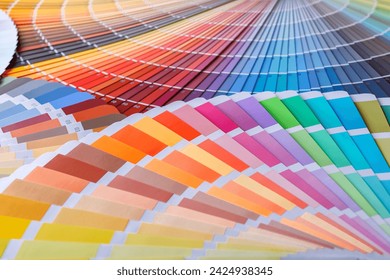 Color wheel for choosing paint tone.Painter and decorator work table with house project, color swatches, painting roller and paint brushes - Powered by Shutterstock