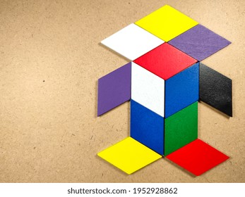 Color Wood Puzzle In Unique Robot Shape On Wood Background With Copy Space.