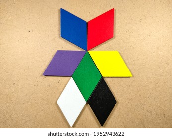 Color Wood Puzzle In Unique Robot Shape On Wood Background.