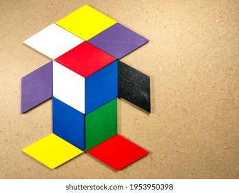 Color Wood Puzzle In Unique Robot Shape On Wood Background With Copy Space.