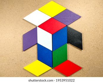 Color Wood Puzzle In Unique Robot Shape On Wood Background.