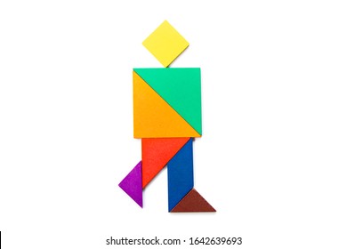 Color wood tangram puzzle in walking man shape on white background