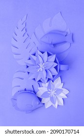 Color of the Year 2022 concept. Very peri, Fish toys set  and origami papercraft flowers, branches, monochrome minimal vacation summer concept, ultraviolet, purple color