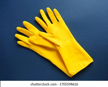 Color yellow cleaning gloves on blue background. Concept cleaning and disinfection room, office, apartments. Copyspace, flat lay, layout, top view - Powered by Shutterstock