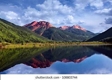 Colorado Mountains San Juan Skyway, Adventure On Red Iron Peaks Reflecting In A Crystal Clear High Mountain Trout Lake, Backpack & Fishing Country With Conifer Pines and Aspens, USA