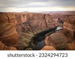 The colorado river flows through Glen Canyon National Recreation Area with the famous Horseshoe Bend located near Page Arizona Geological erosion creates colorful patterns along the canyon walls