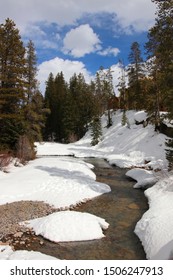 Colorado Snowy Early Spring Beautiful Nature Background. Scenic View With Water Stream On A Covered By Snow Valley Between Rocky Mountains. Amazing Keystone Landscape, Colorado, USA.