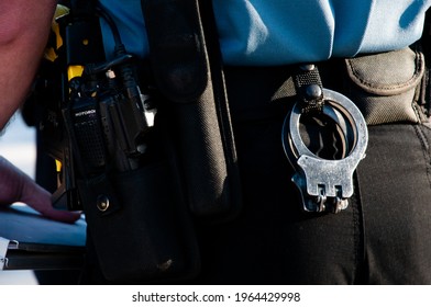 Colorado Springs - October 16th, 2011 - 
A police officer's utility belt holds handcuffs with the yellow of a tazer visible on the left.
