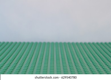 Colorado, USA - April 27, 2017: Studio shot of green LEGO baseplate with light blue background.