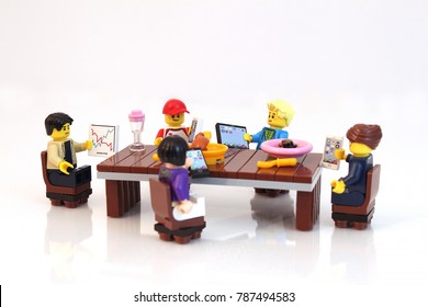 Colorado, USA - January 5, 2018: Studio shot of Lego minifigure people at dinner table all on their phone and devices ignoring each other.