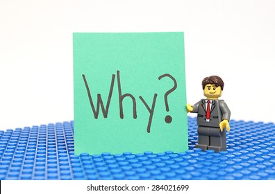 Colorado, USA - June 1, 2015: Studio shot of Lego minifigure with Why? sign. Legos are a popular line of plastic construction toys manufactured by The Lego Group, a company based in Denmark.