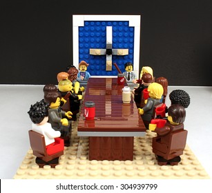 Colorado, USA - June 27, 2015: Studio shot of Lego minifigures portraying board meeting scene on white background.