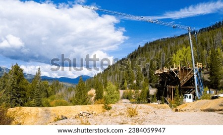 Colorado's abandoned Jessie Mill near Breckenridge in Summit County, in the Rocky Mountains, under restoration, with a crane in view, in fall autumn of 2023. Abandoned Jumbo Mine nearby.