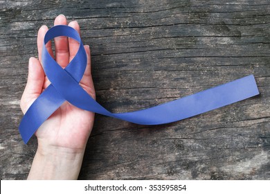 Colorectal Colon cancer, Acute Respiratory Distress Syndrome (ARDS), Juvenile Arthritis and Tuberous Sclerosis, Guillain Barre syndrome awareness with dark blue ribbon on helping hand aged background