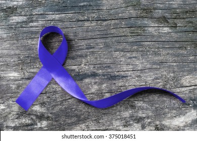 Colorectal/ Colon Cancer, Juvenile Arthritis, Cri Du Chat And Acute Respiratory Distress Syndrome (ARDS) Awareness With Dark Blue Ribbon On Old Aged Wood 