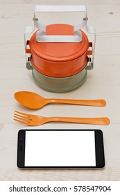 Colored Asian-styled Food Containers Calling Bento With Funny Spoon And Fork And A Cell Phone For Some Internet Browsing During The Lunch