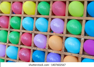 Colored balloons dart game background. Playgame is throwing darts into colorful ballon, entertainment in the park for children.