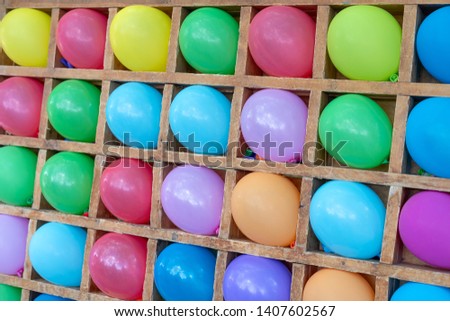 Colored balloons dart game background. Playgame is throwing darts into colorful ballon, entertainment in the park for children.