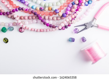 Colored Beads. Glass And Stone Beads For Jewelry Making On White Background. Hobby, Handmade, Fine Arts. Selective Focus