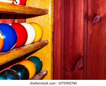 Colored Billiard Balls On A Wooden Shelf. Billiard Ball. Wooden Shelf. Numbered Balls. Gambling. Sports Game. Leisure Activities. Business. Background Image.