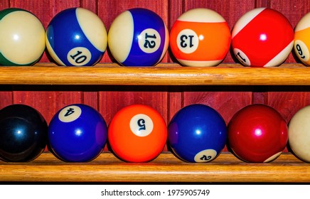 Colored Billiard Balls On A Wooden Shelf. Billiard Ball. Wooden Shelf. Numbered Balls. Gambling. Sports Game. Leisure Activities. Business. Background Image.